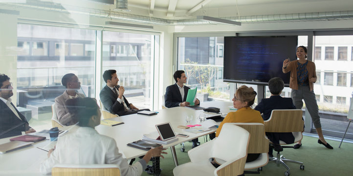 Businesswoman leading conference room meeting