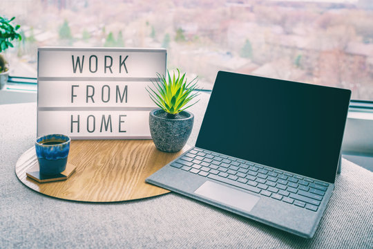 Working from home remote work inspirational social media lightbox message board next to laptop and coffee cup for COVID-19 quarantine closure of all businesses.