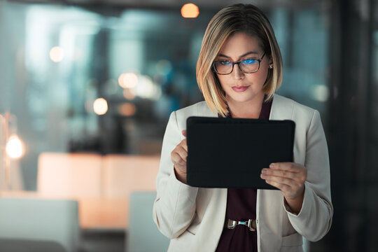 Business woman, typing and tablet in office for corporate communication, internet research and networking. Female person, technology and working late night for project planning and company email