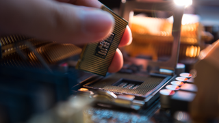 Somebody placing a CPU component onto a circuit board