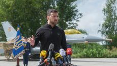 president of Ukraine Volodymyr Zelenskyi stands in front of the first General Dynamics F-16 Fighting Falcon received by Ukraine as he congratulates Ukrainian military on the Day of Ukrainian Air Force on August 4, 2024 