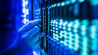 A hand working on a server rack