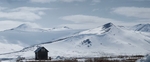 Color landscape photograph of snow covered mountains on Taylor Highway in Nome Alaska
