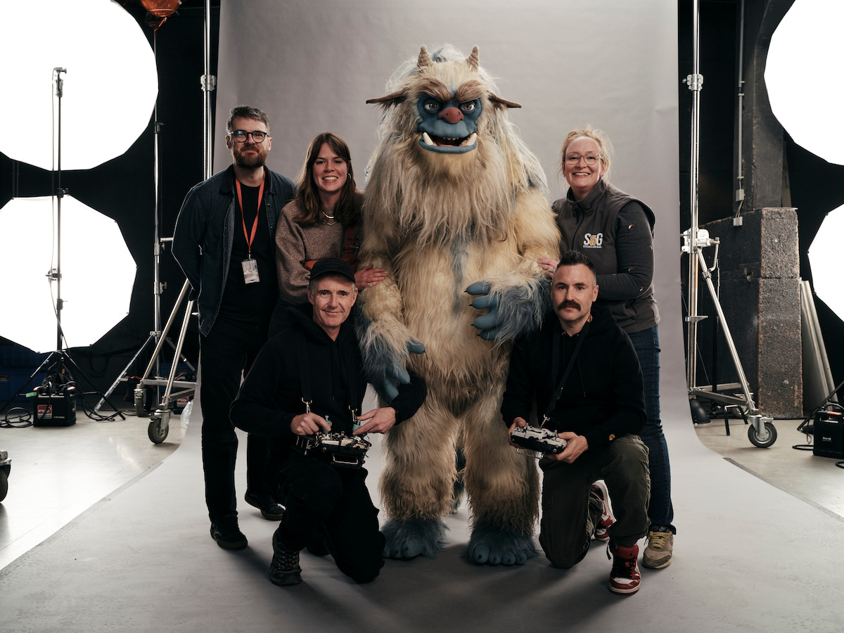 The operation and production crew posing for a photo with the puppet in ‘Eric’.