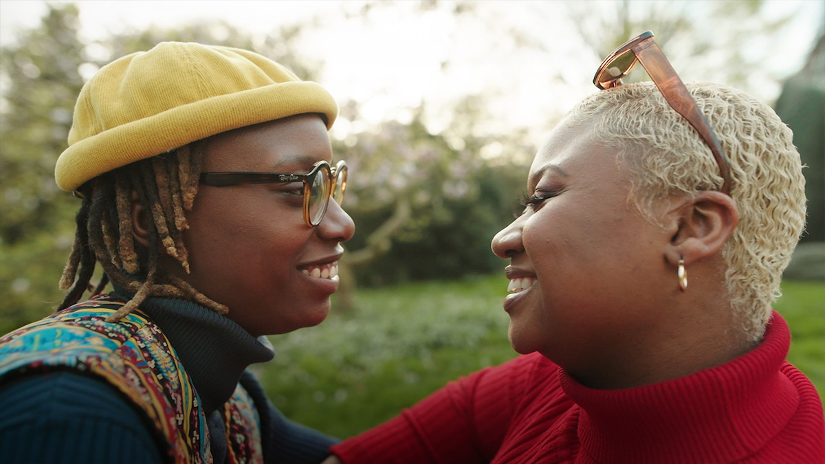 The Bridgerton Fan Wedding couple, Shanti and Tiffany, look at each other smiling 