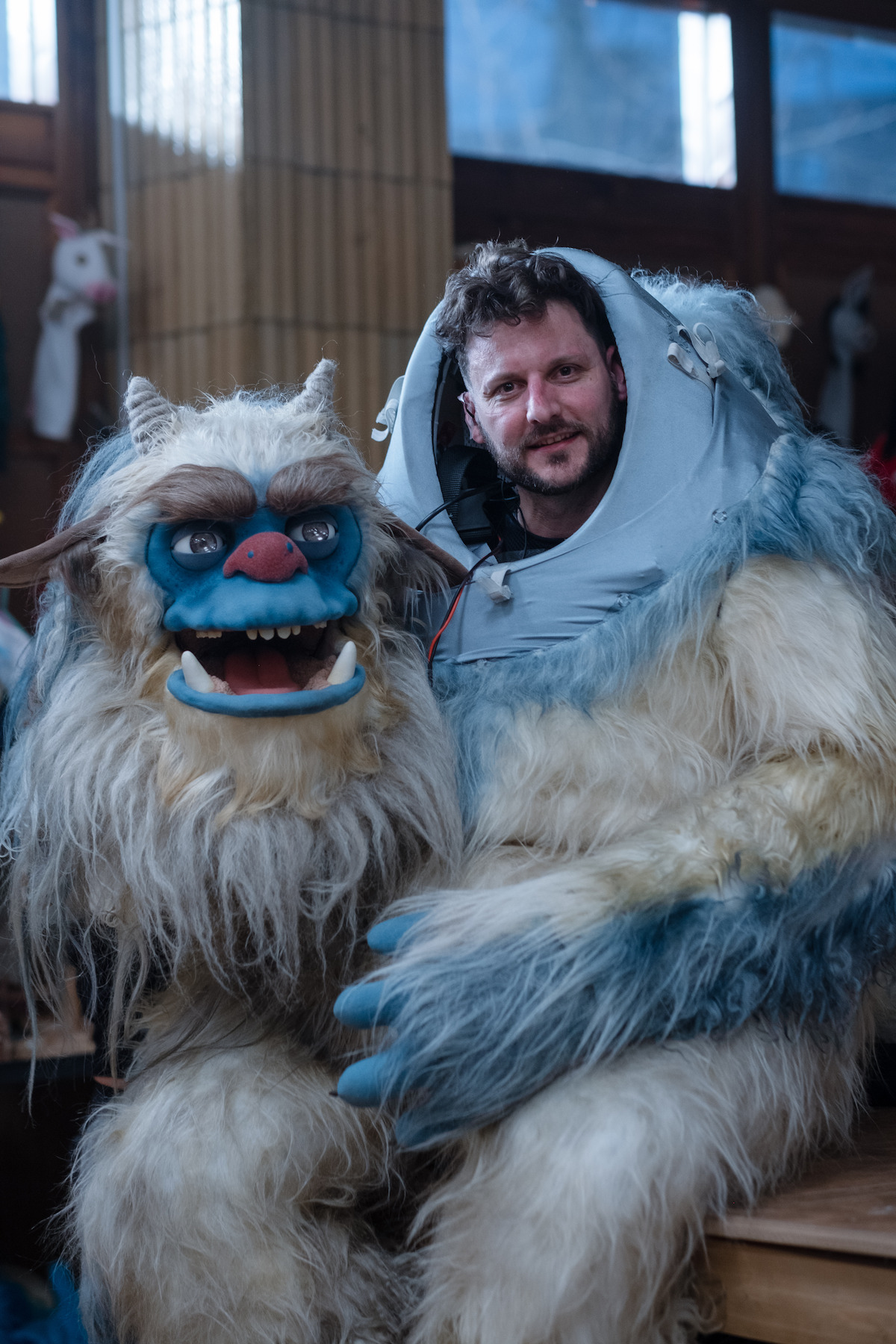 Man sitting in the puppet suit in ‘Eric.’