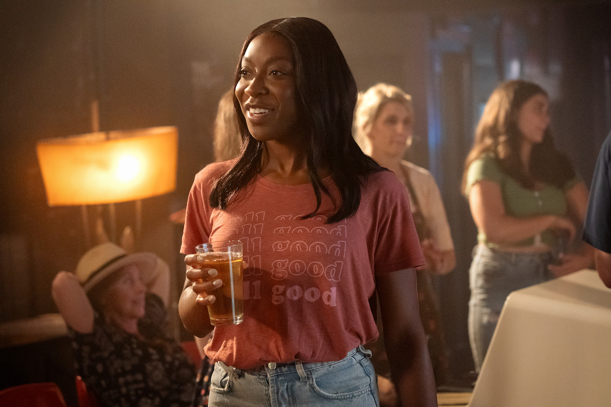 Ego Nwodim as Claire holding a beer in ‘Players.’