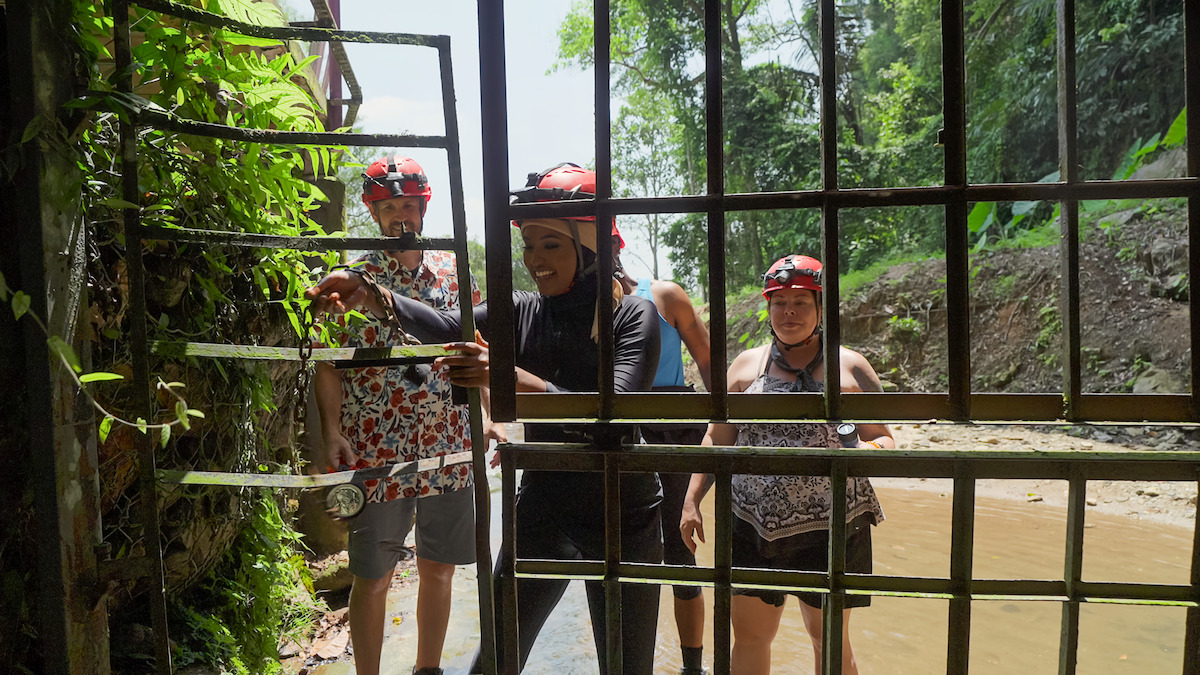 Sean Patrick Bryan, Muna Abdulahi, and Deanna Thompson open a gate during a challenge.