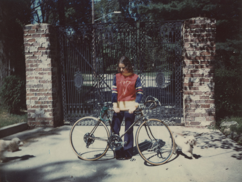 Marliz in front of her childhood home with her bike.  