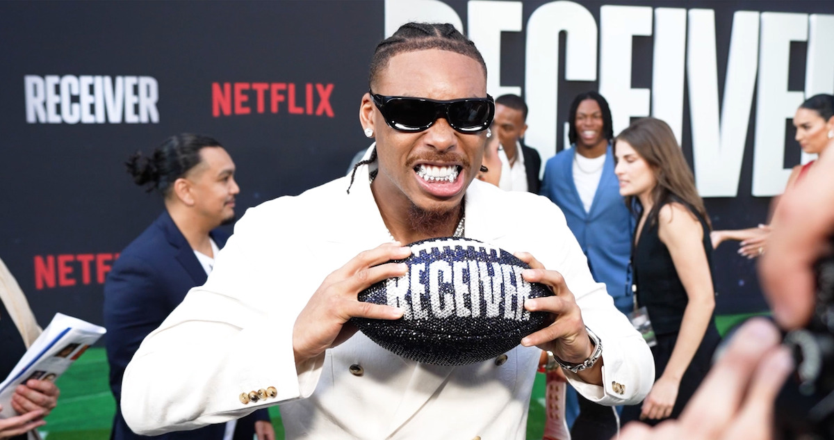 Justin Jefferson holding a football at the premiere of Receiver.