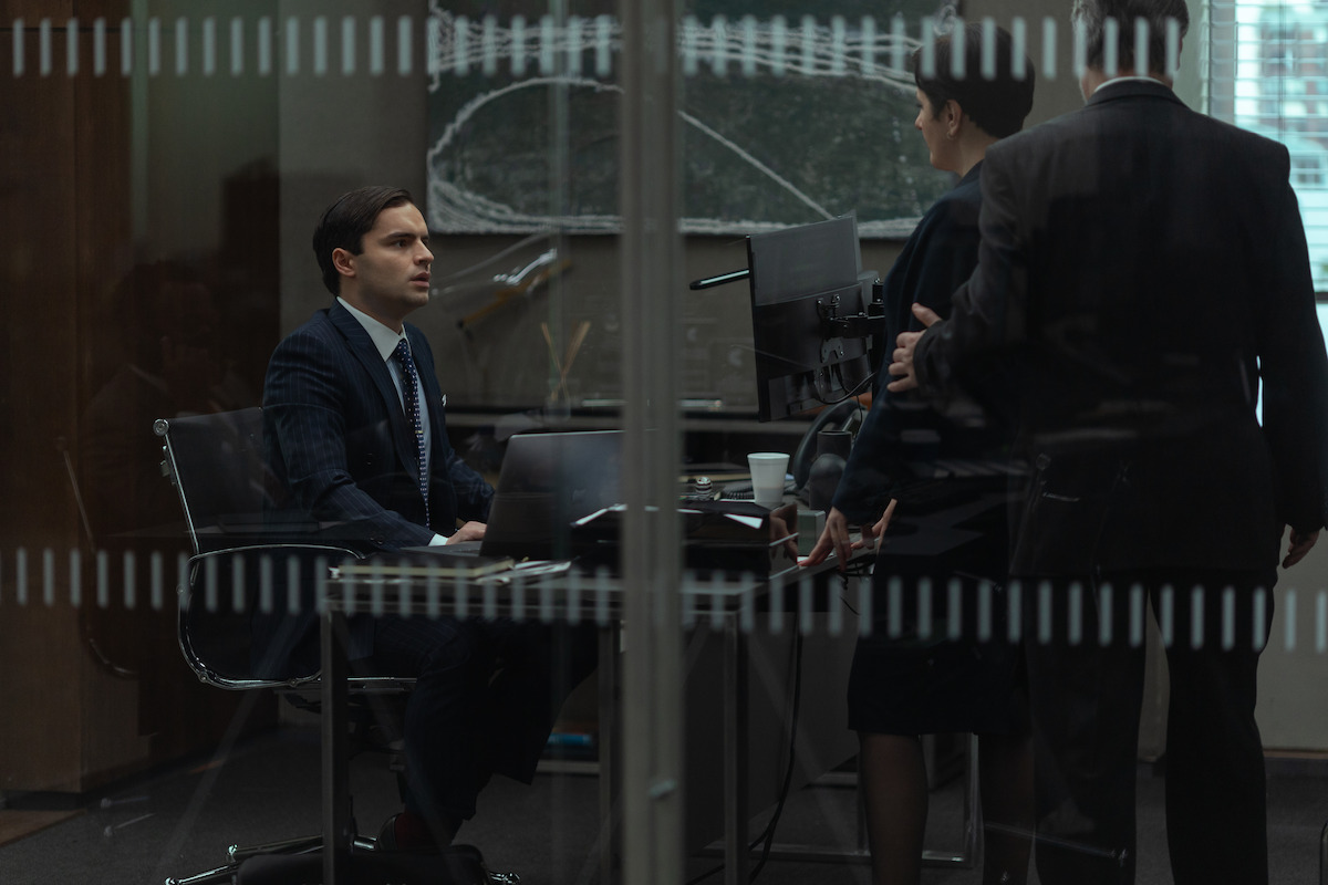 Sebastian De Souza as Rory sits at a desk.