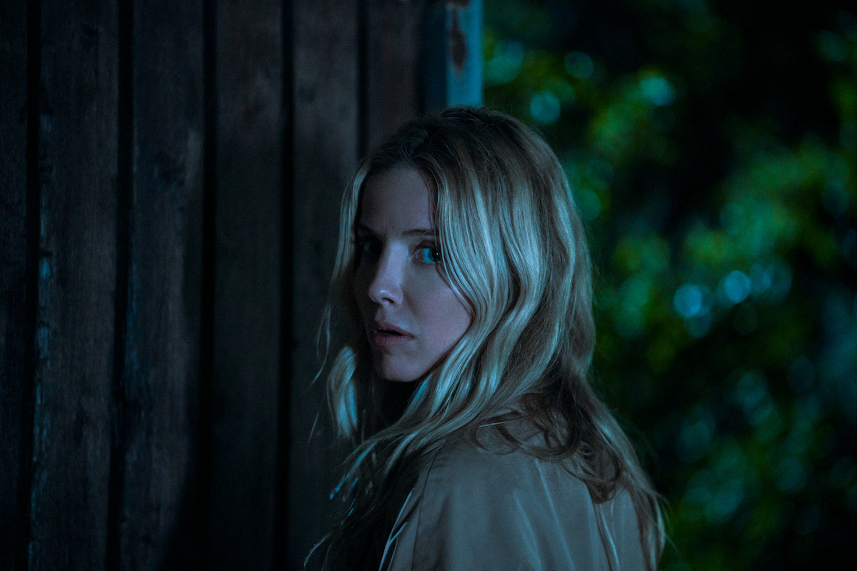 Annabelle Wallis as Elena looks over her shoulder outside at night in the film ‘Vanished into the Night.’