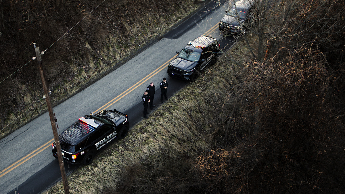 Police standing on the edge of a road in a scene from ‘Unsolved Mysteries’.