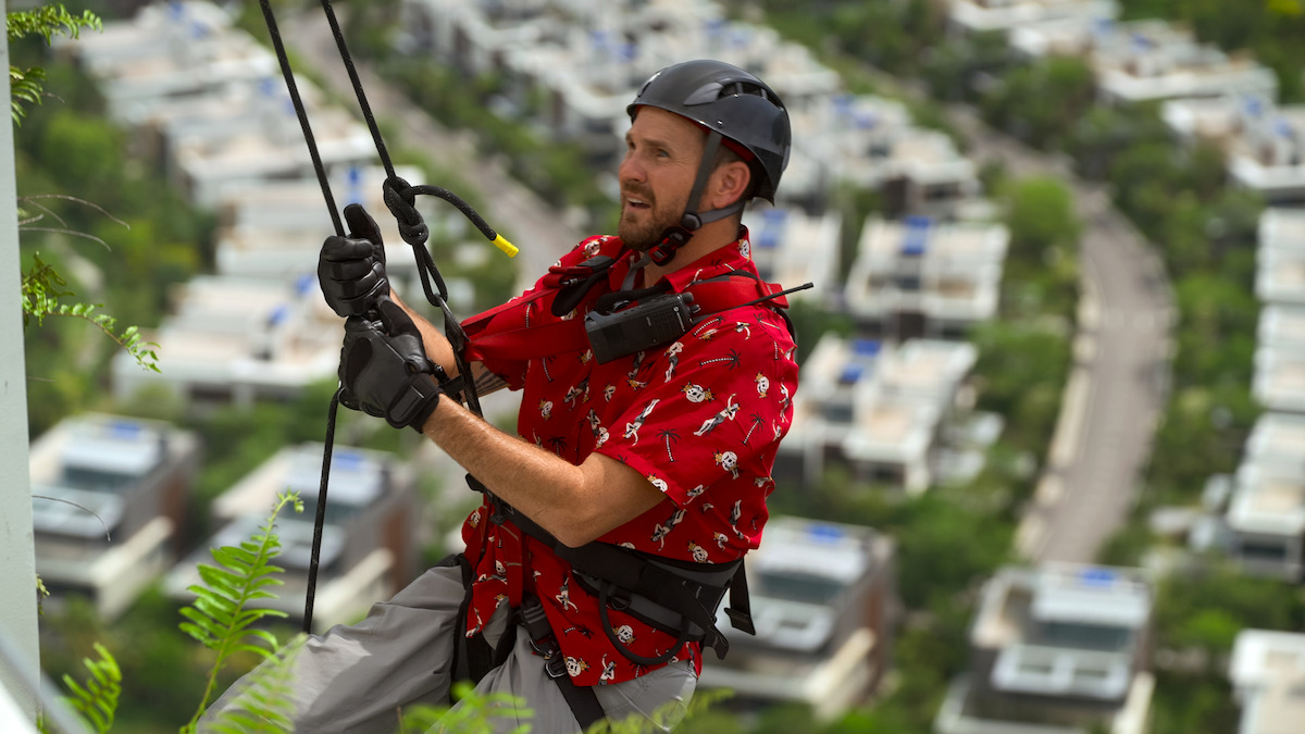 Sean Patrick Bryan rappels down the side of a building during a challenge.