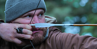 Zach Owens drawing his bow.