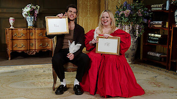 Luke Newton and Nicola Coughlan smile together playing a friendship challenge game