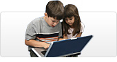 A boy and girl at a laptop