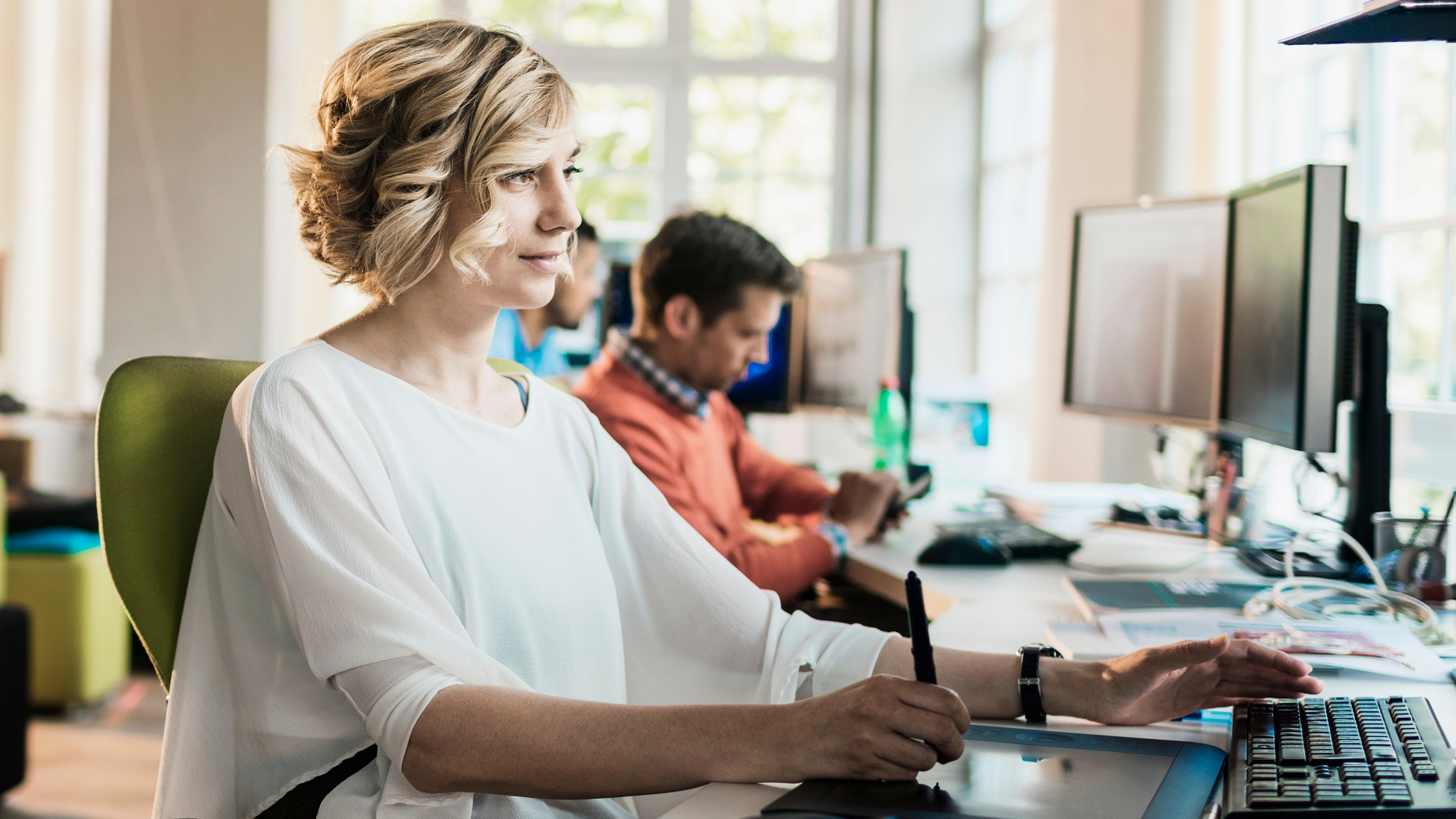 woman typing on a keyboard in an office setting