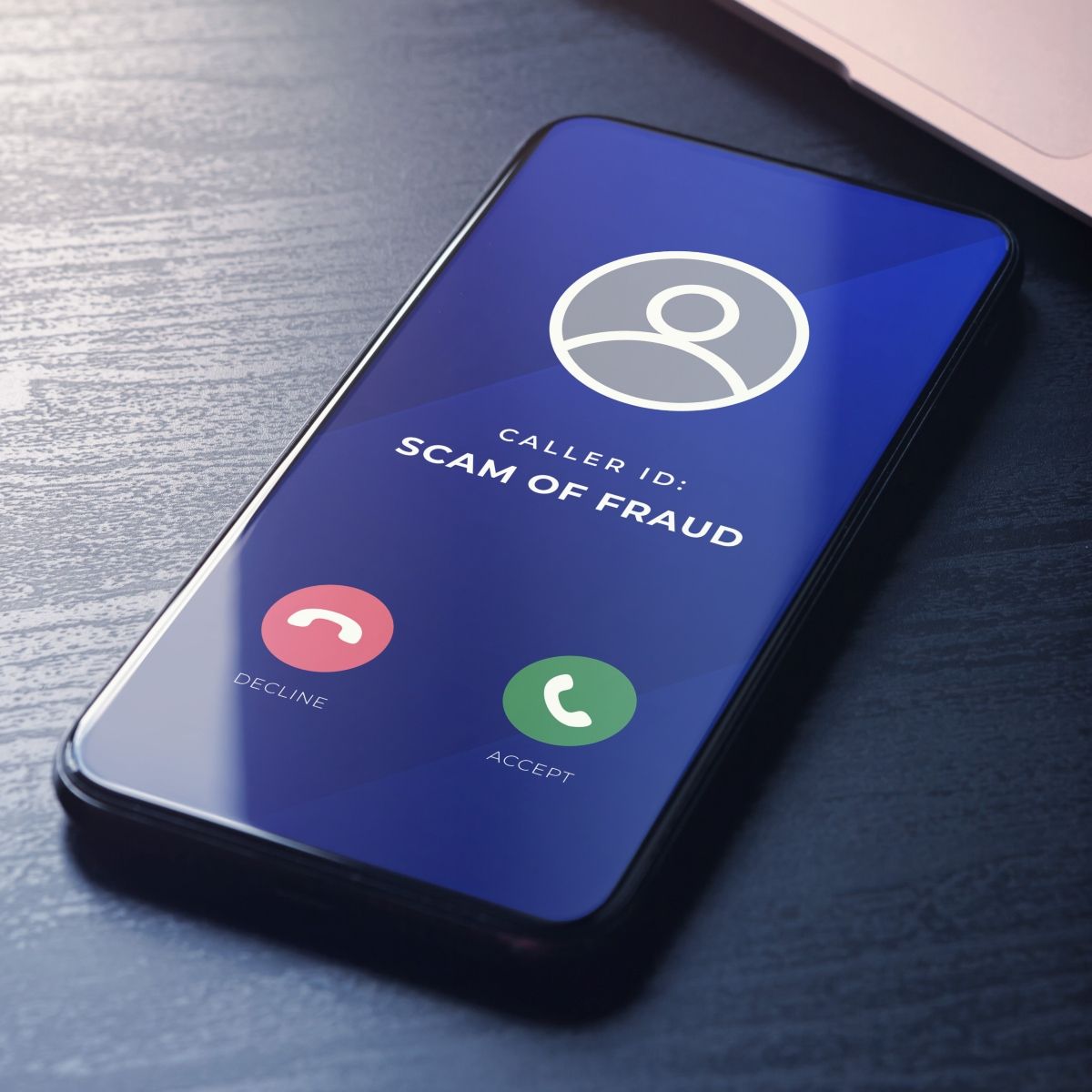 Cellphone screen incoming call with caller id saying SCAM OF FRAUD 