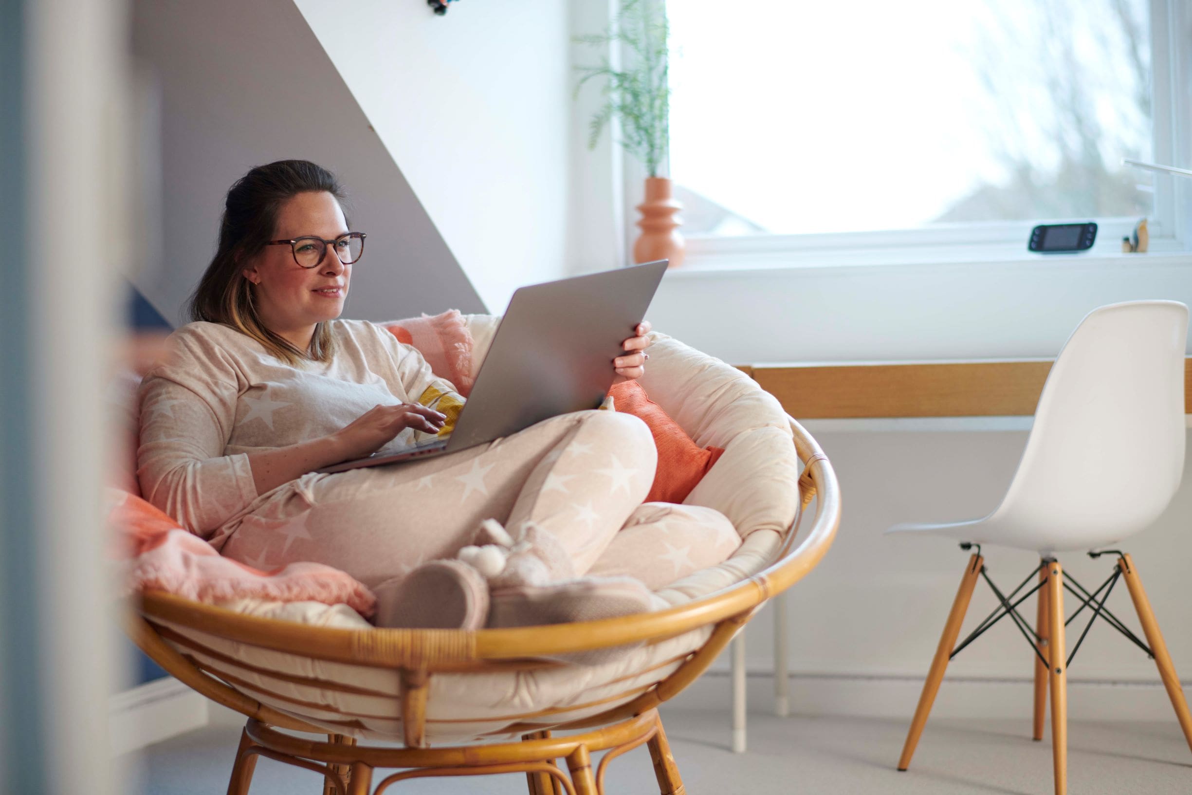 Woman sitting and working on laptop