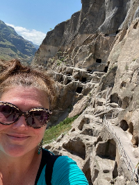 Chassity smiling on a cliffside hike.