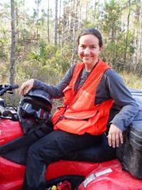 Helena smiling while sitting atop an ATV.