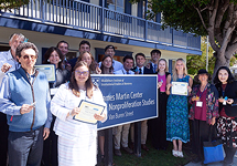 Students, experts, and donors standing around the CNS sign