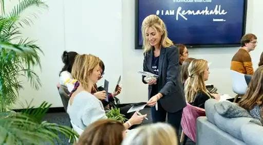 Woman handing out leaflets at a workshop