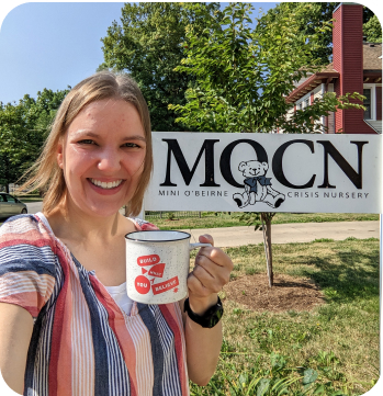 smiling woman holding coffee cup