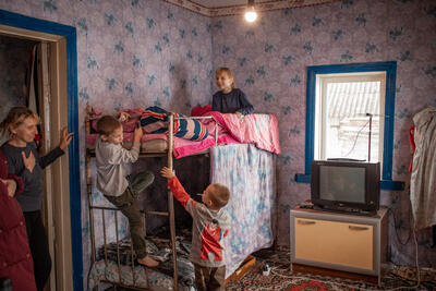 Olha and her children are kept warm in a shelter in a village in the Chernihiv Region, north Ukraine, as part of a winter campaign by aid workers.