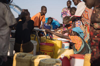 People displaced by floods collect water at a distribution point in Bentiu IDP site D, Robkona County, Unity State, South Sudan