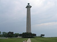 Doric column-shaped tower with trees at its base