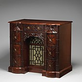 Kneehole writing table; circa 1760; mahogany, mahogany veneer and gilt bronze; 88.9 × 97.8 × 62.2 cm; Metropolitan Museum of Art (New York City)