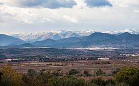 Photo; large row of snowy-capped rocky mountains