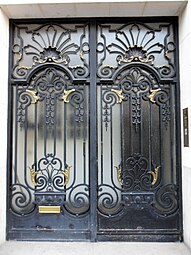 Door of Rue Guynemer no. 2, Paris, with palmettes, shells, volutes, garlands, proportions and other elements seen on wrought iron, furniture, textiles and ceramics from the reign of Louis XIV