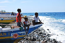 Children sitting on fishing boats in Suco Maquili, Atauro, in 2010
