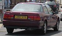 Rear view of a two-door car with a three-box body style.