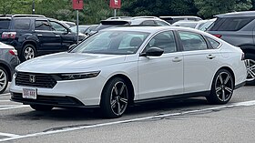 Front three-quarter view of a front-engined four-door car.