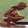 A Balinese squatting wooden statuette.