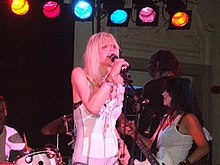 Woman in corset holding microphone onstage