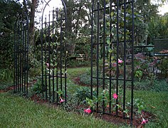 A series of trellises forms the wall of a garden room.