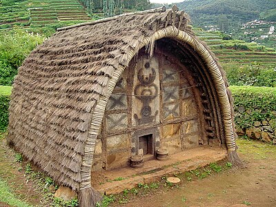 The Temple of a Toda Tribe of Nilgiris, India. Note the art on the front & the tiny door.