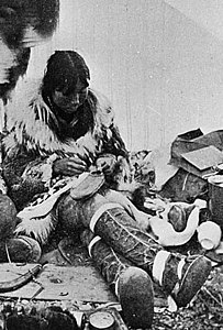 Making waterproof summer overshoes in a tent,[4] c. 1900, Port Clarence, Alaska