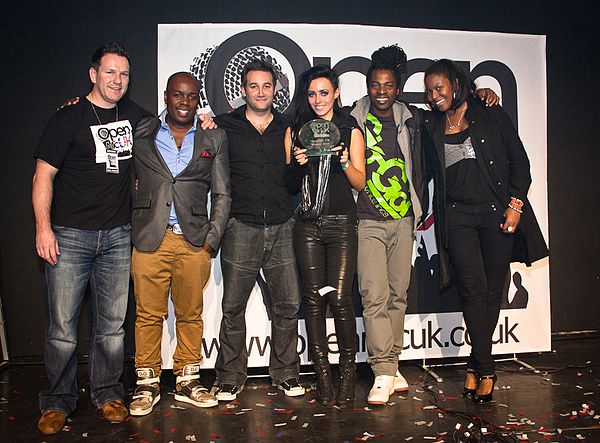 Ras Kwame (centre) as judge at Open Mic UK, 2010