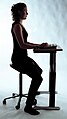 Balanced sitting by using a specialised chair to replicate partial squatting more authentically – more weight on feet.