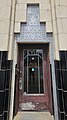 Entryway with art deco ornamentation and "KYLE" over the door