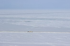 Aerial view of the highway with the Trans-Alaska Pipeline in the background (14 April 2015)