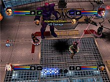 In each corner of the screen a playable character's head appears, along with a red and blue bar extending horizontally back towards the center of the screen. At the bottom center five large circular "X" logos are seen, with three being brighter. To the left center are two glowing orbs with numbers representing their availability. In the center a beam is being fired at an off screen enemy, while another character advances towards a large robot.