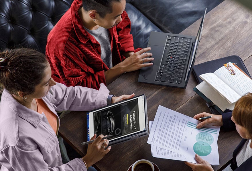 Lenovo ThinkPad X1 Yoga Gen 8 2-in-1 laptop in tent mode next to a wireless keyboard, being used with the integrated pen.