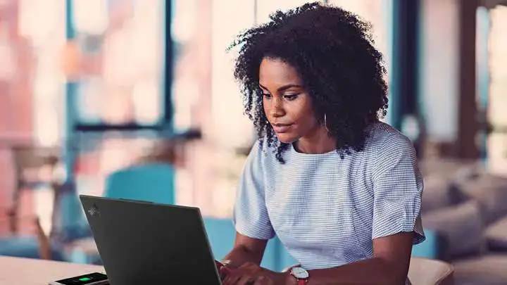 A woman typing on her laptop